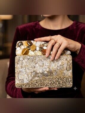 This is a rigid, box-style clutch bag with a rectangular base.